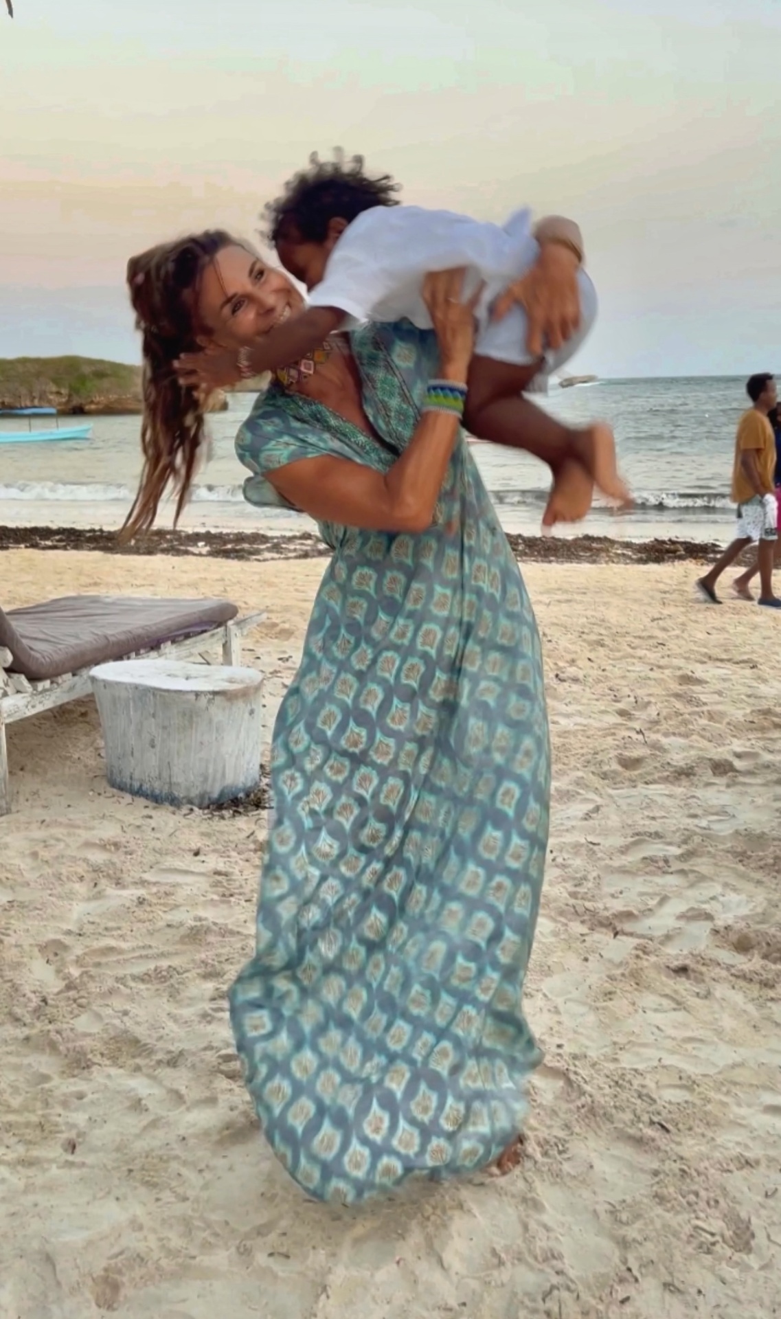 Michy with little Jordi on Watamu beach at sunset